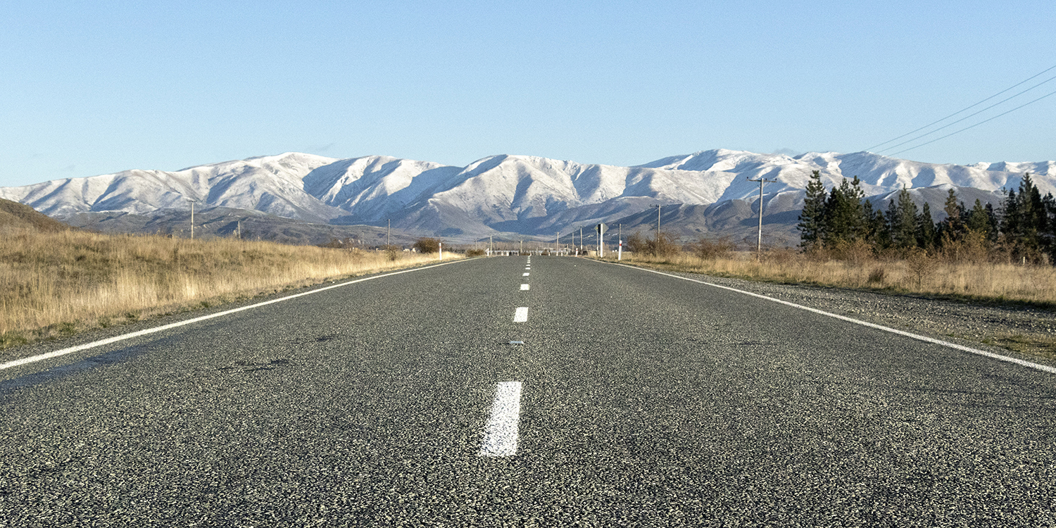 South Island road in winter heading toward mountains surrounding the Mackenzie Basin