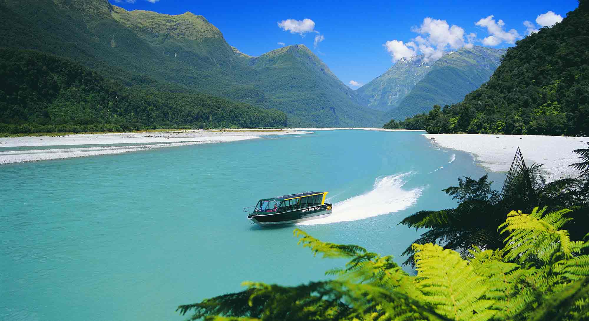 Haast River safari jetboat speeding down the river.