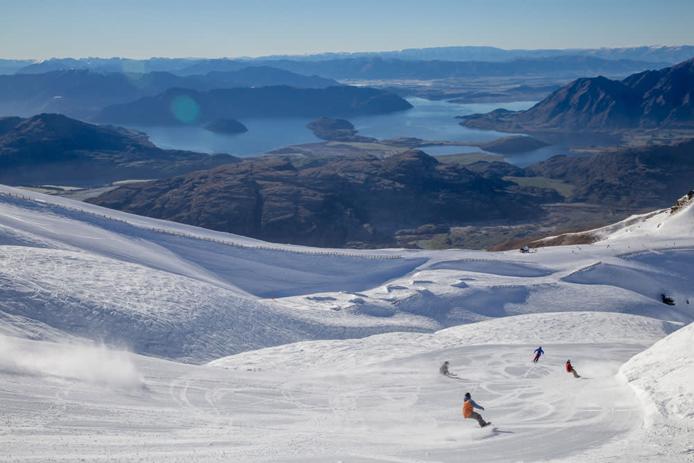 Treble Cone with skiers and the view of Lake Wanaka